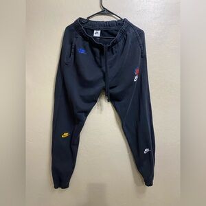 Nike Black Sweatpants with multicolor Emblems for Men Women.